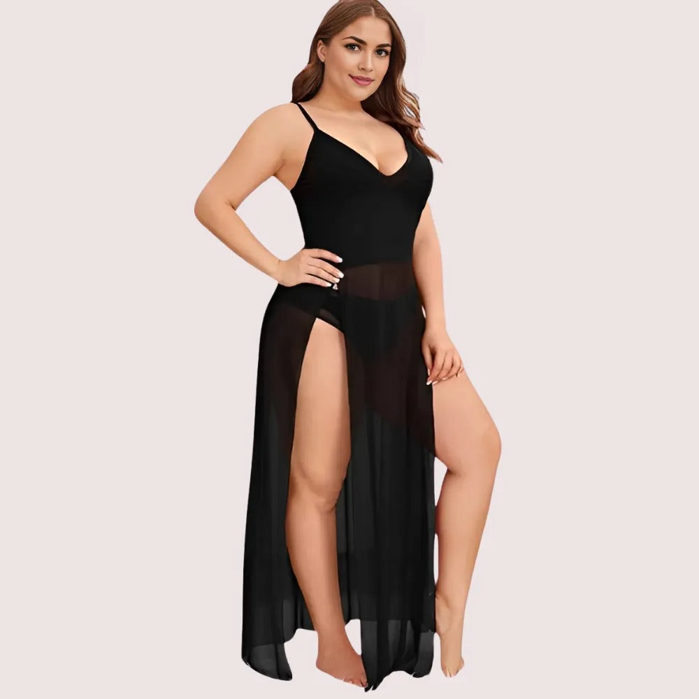 Woman wearing a black dress with a high slit on a light pink background