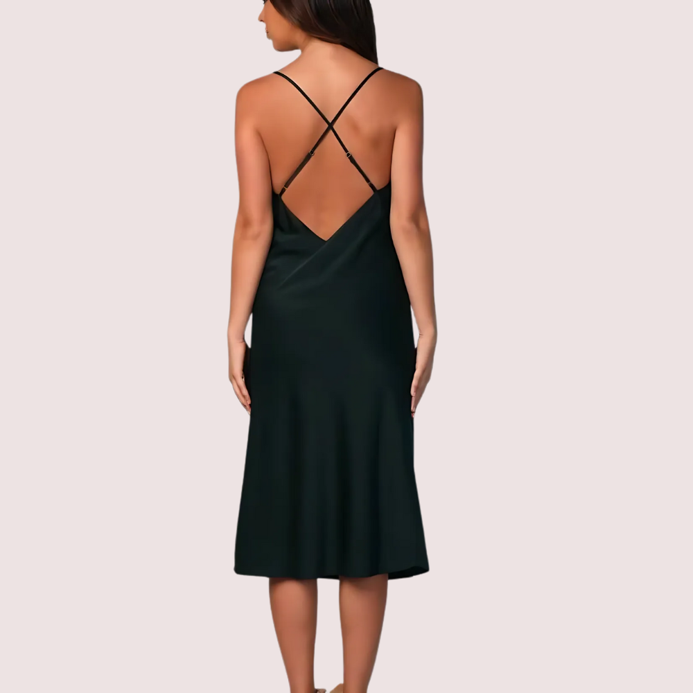 Black dress with criss-cross back design on a plain background