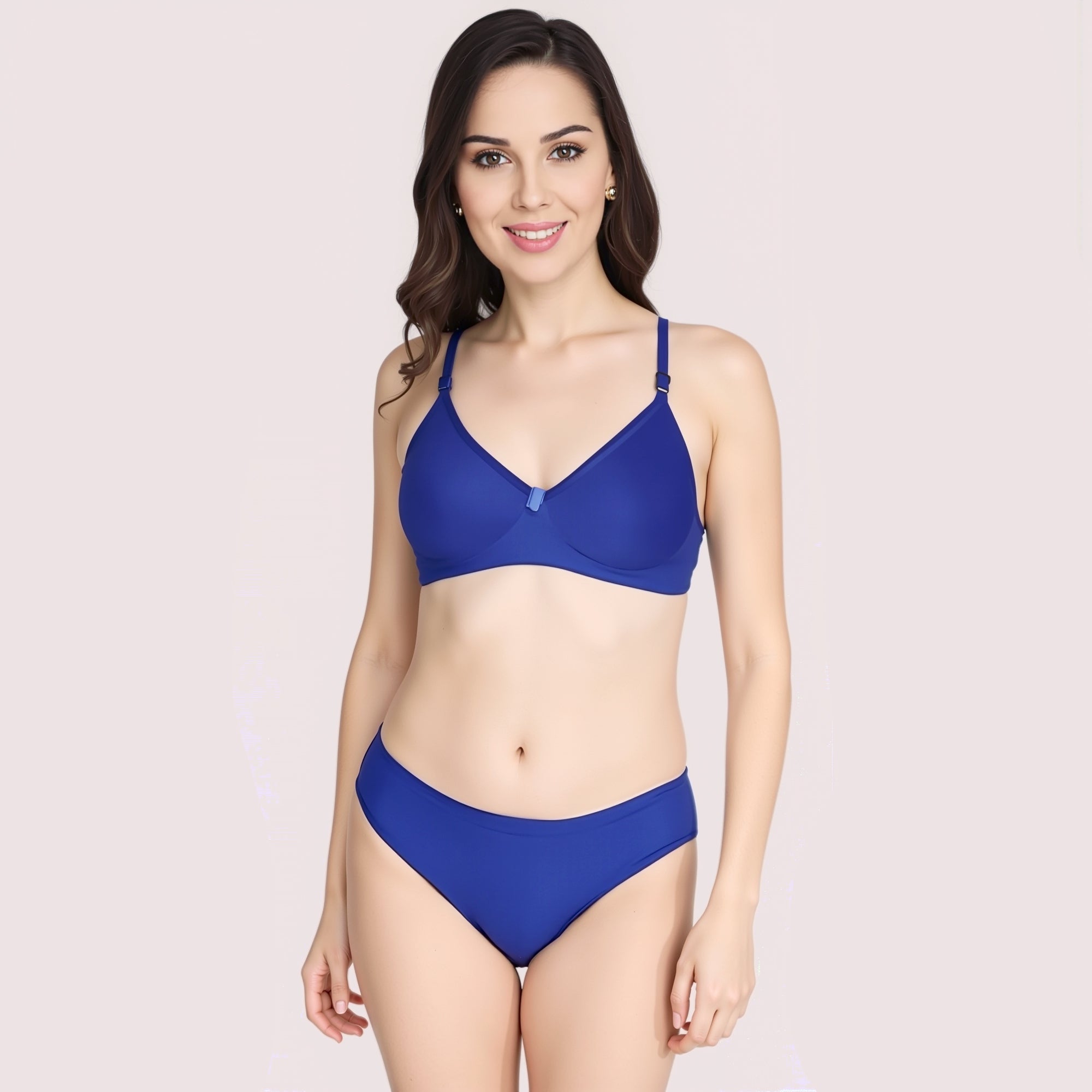 Woman wearing a blue bikini set on a light pink background