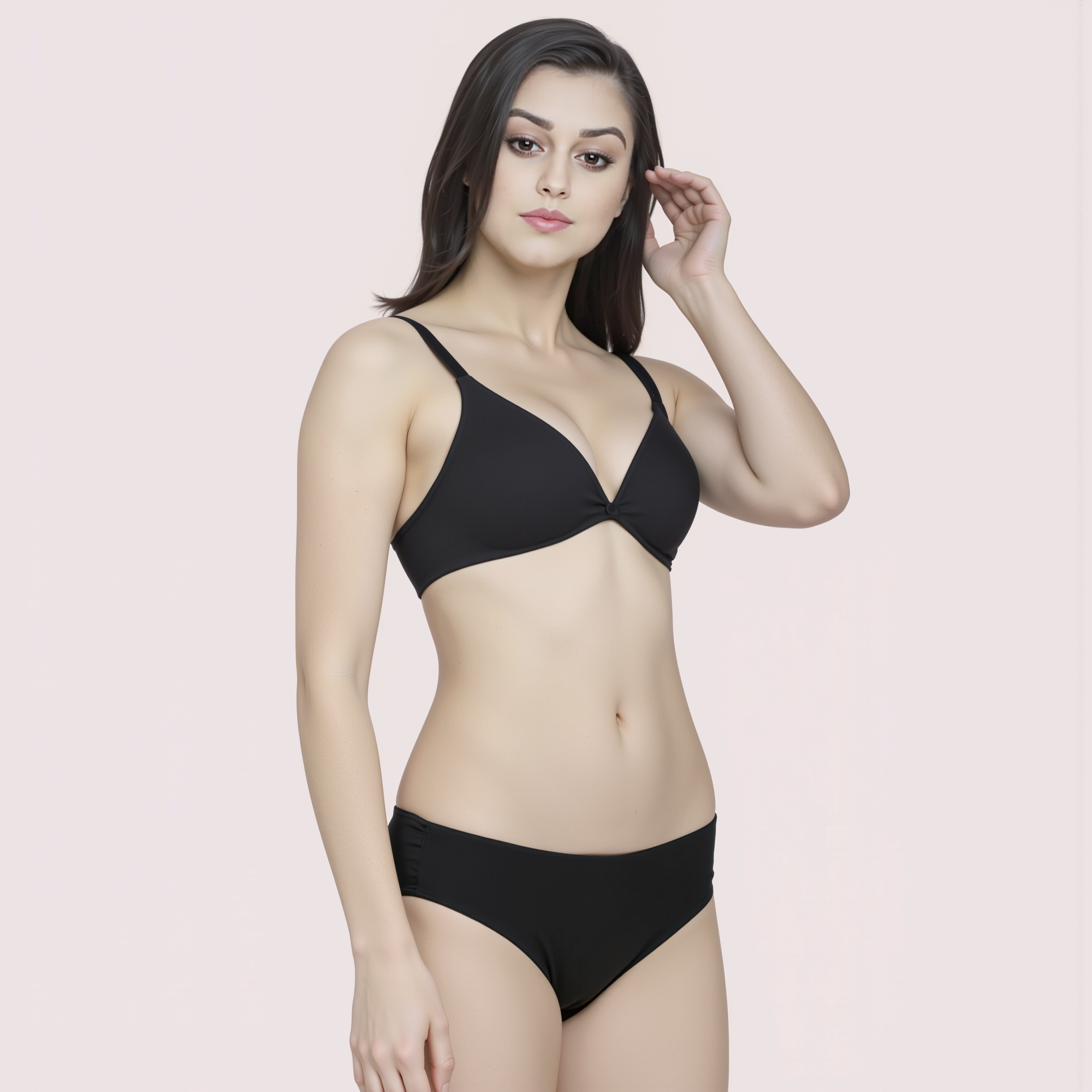 Woman wearing a black bikini set on a light pink background