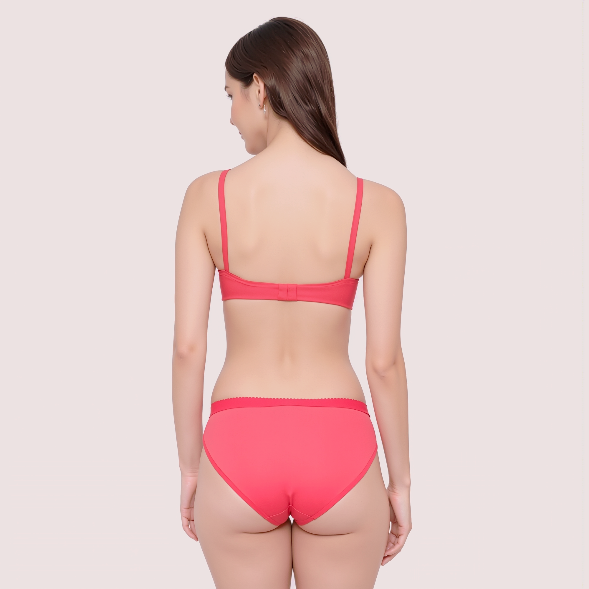 Woman wearing a red bikini set on a light pink background