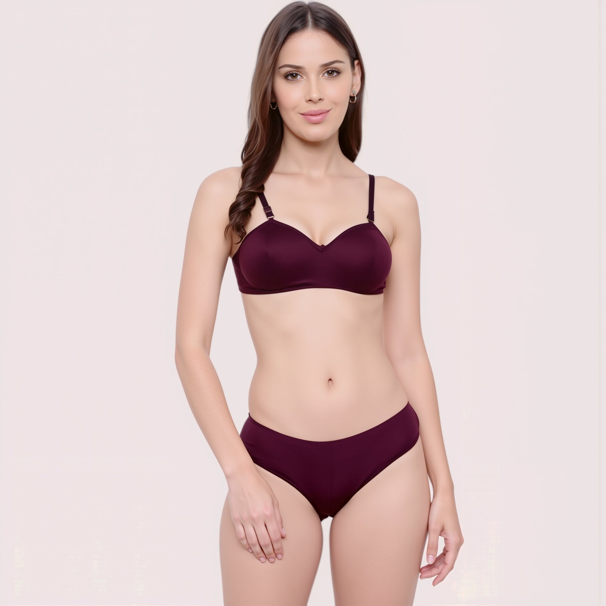 Woman wearing a maroon bikini set on a light pink background
