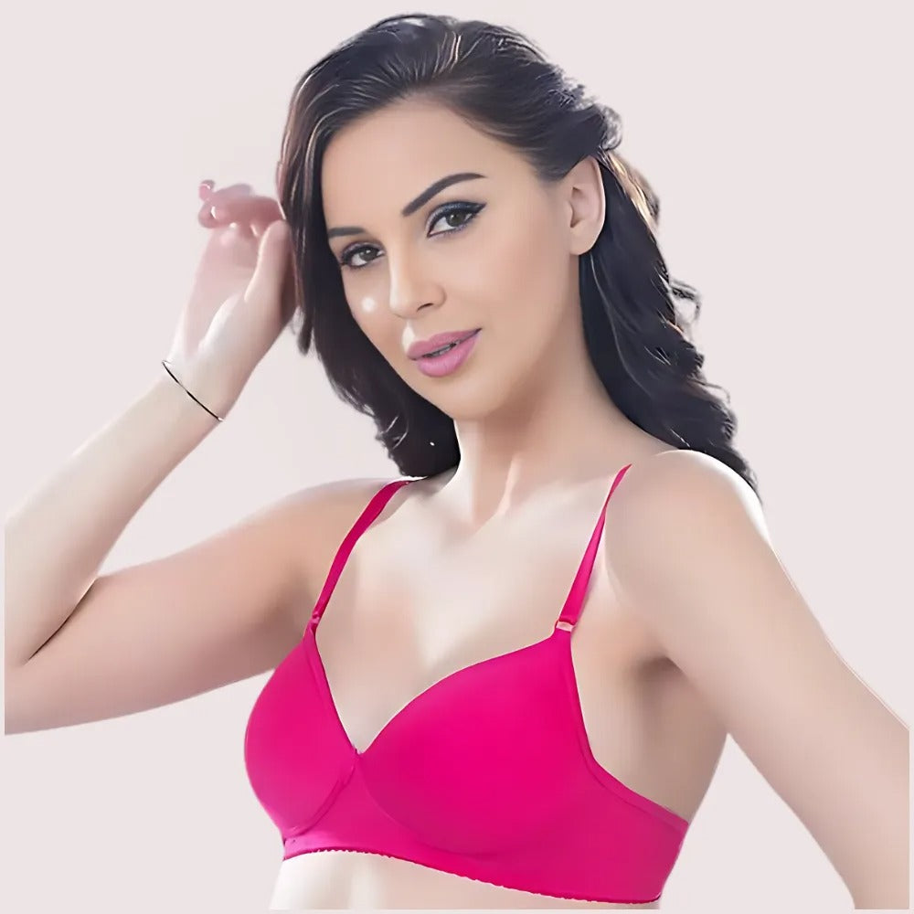 Woman wearing a pink bra against a light background