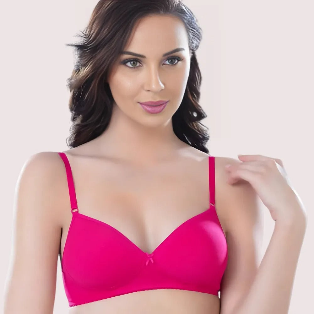 Woman wearing a pink bra against a plain background