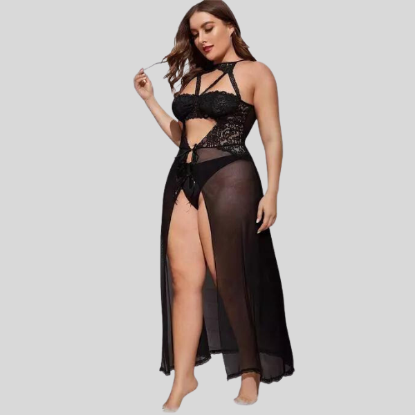 Woman wearing a black lace lingerie set with sheer overlay on a gray background