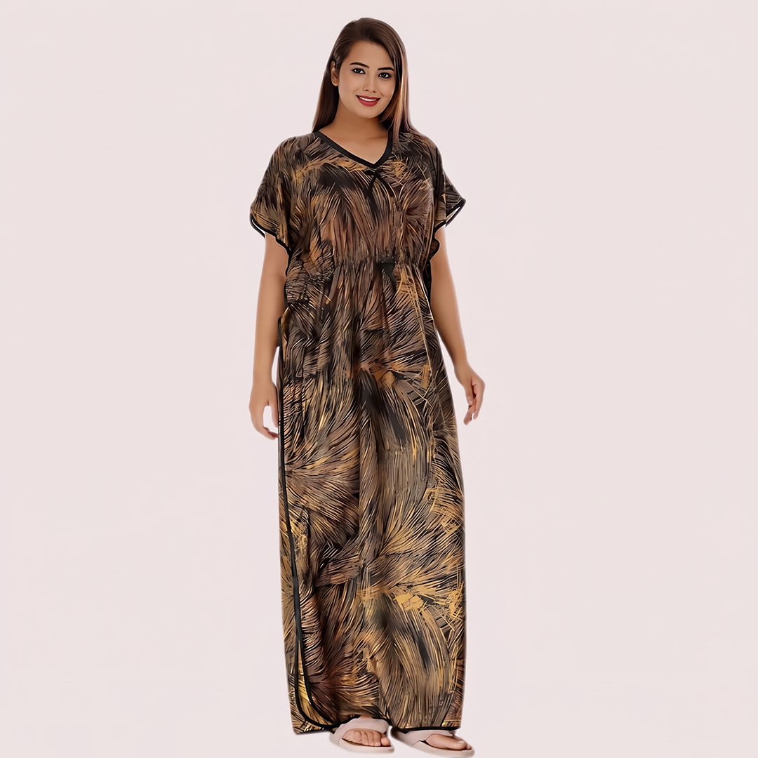 Woman wearing a long, patterned dress on a plain background