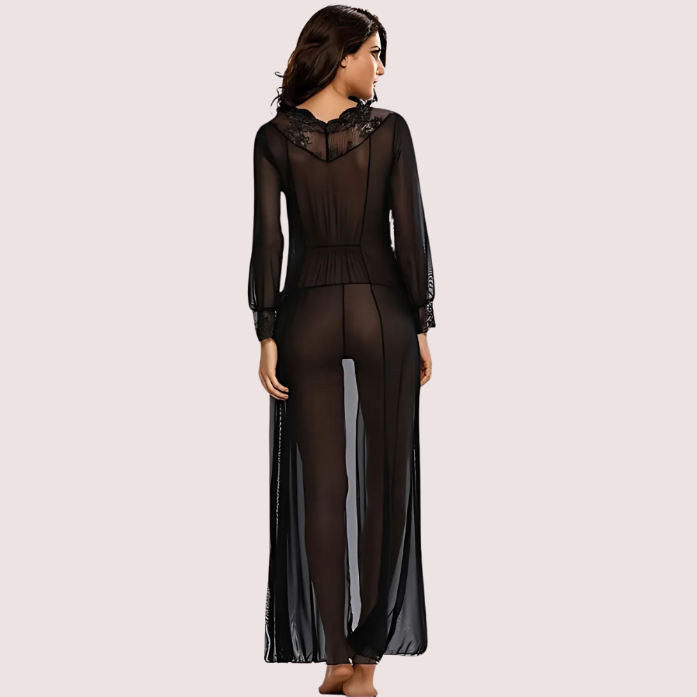Woman wearing a sheer black outfit on a light pink background