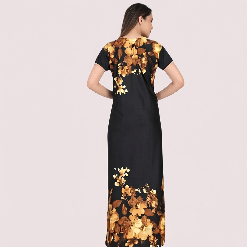 Black dress with gold floral patterns on a plain background