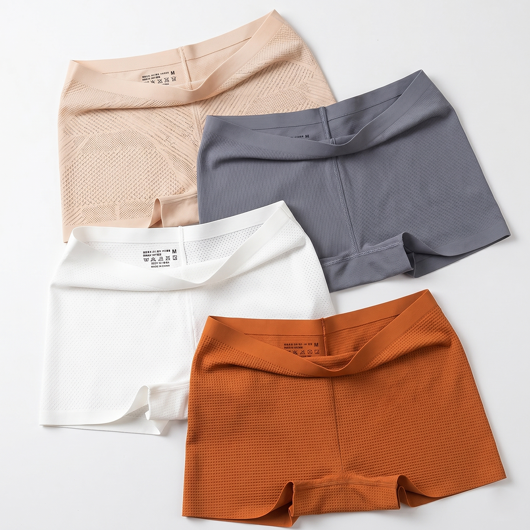 Four pairs of men's underwear in beige, gray, white, and orange on a light gray background.