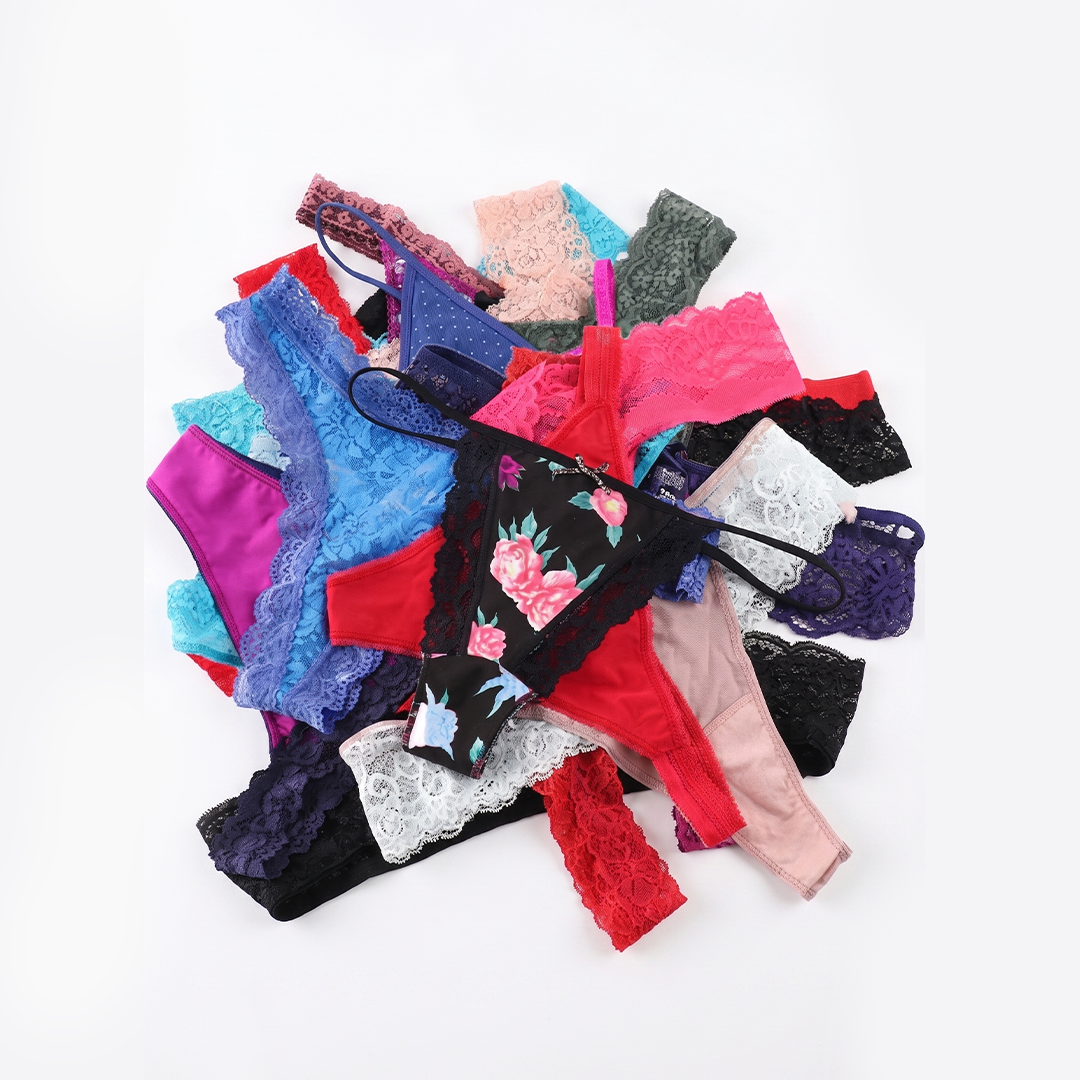 Assorted colorful bras and panties on a white background