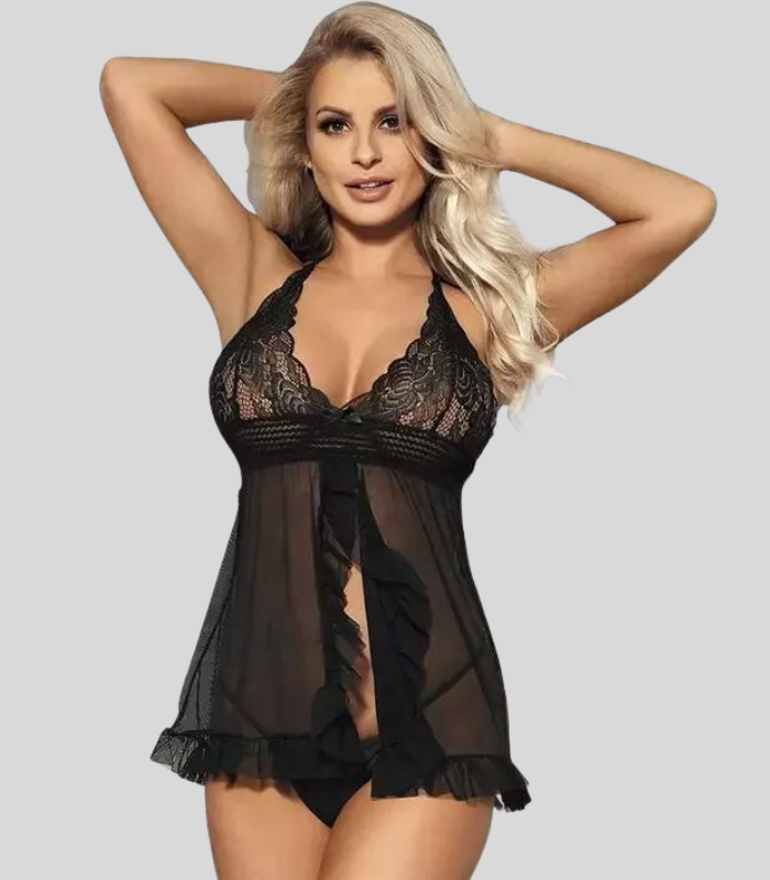 Woman wearing a black lace lingerie set against a plain background