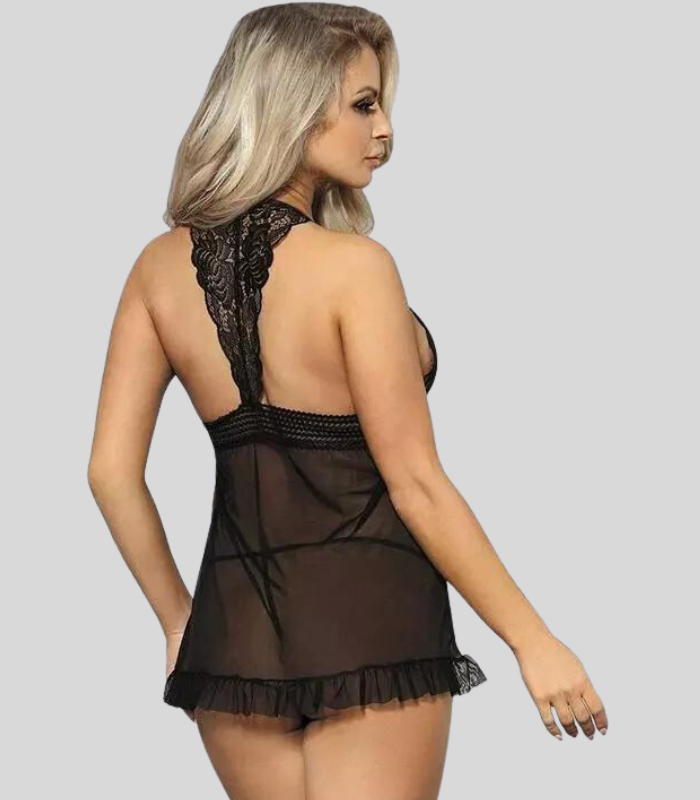 Woman wearing a black lace nightgown against a gray background