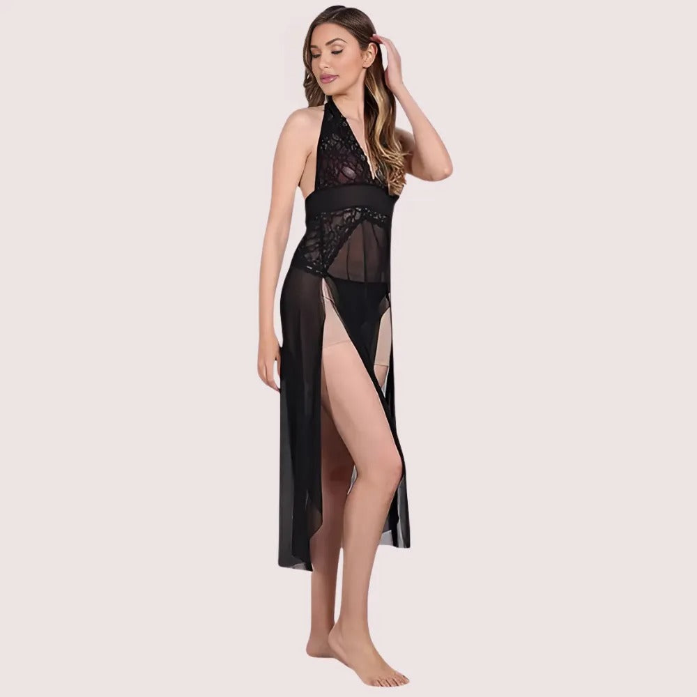 Woman wearing a black lace nightgown on a light pink background