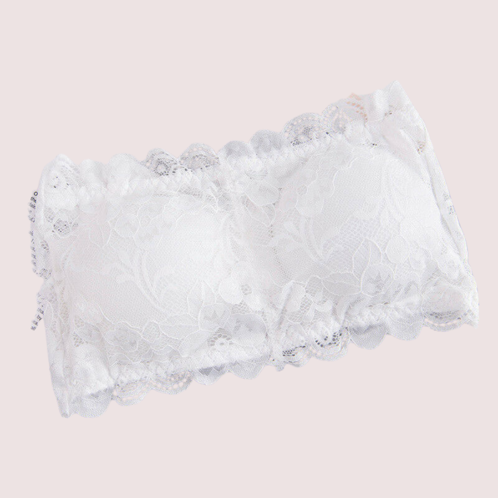 White lace bralette on a light pink background