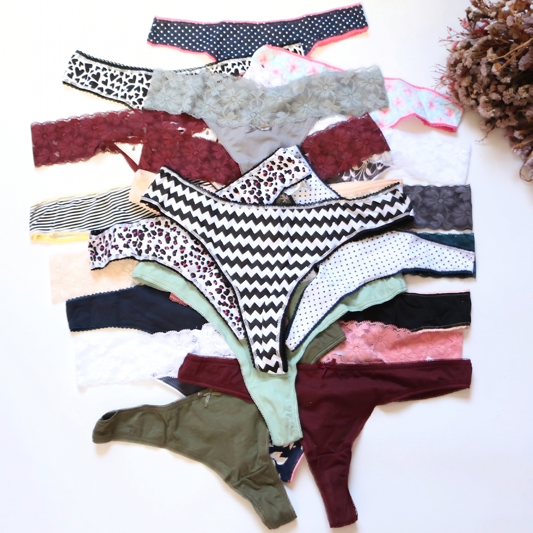 Assorted patterned underwear on a white surface with decorative elements.