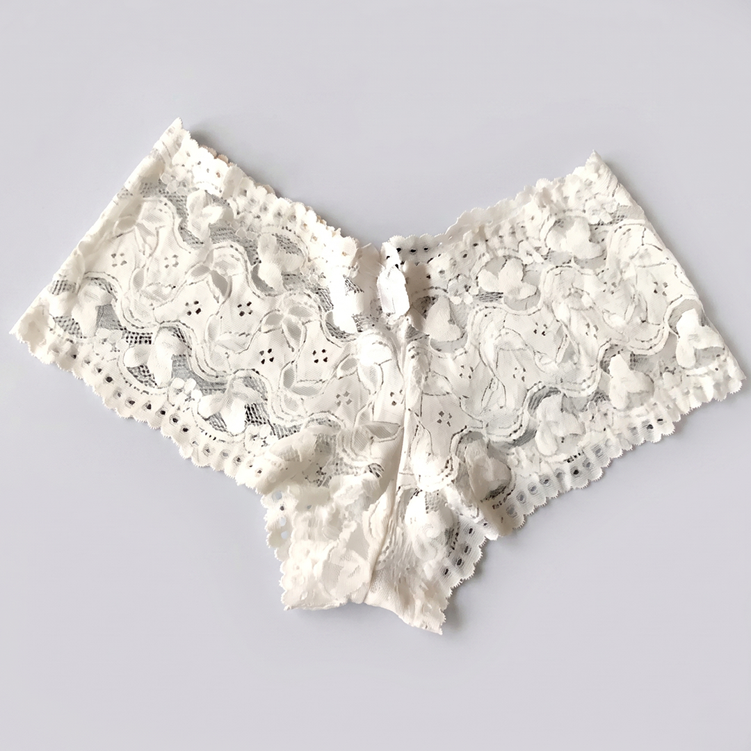 White lace bralette on a light gray background
