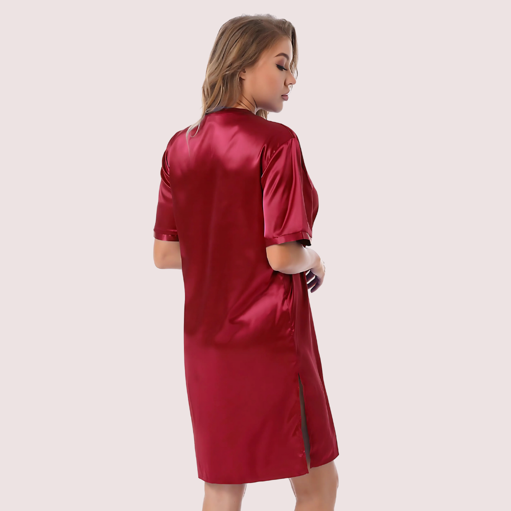 Woman wearing a red satin robe on a beige background