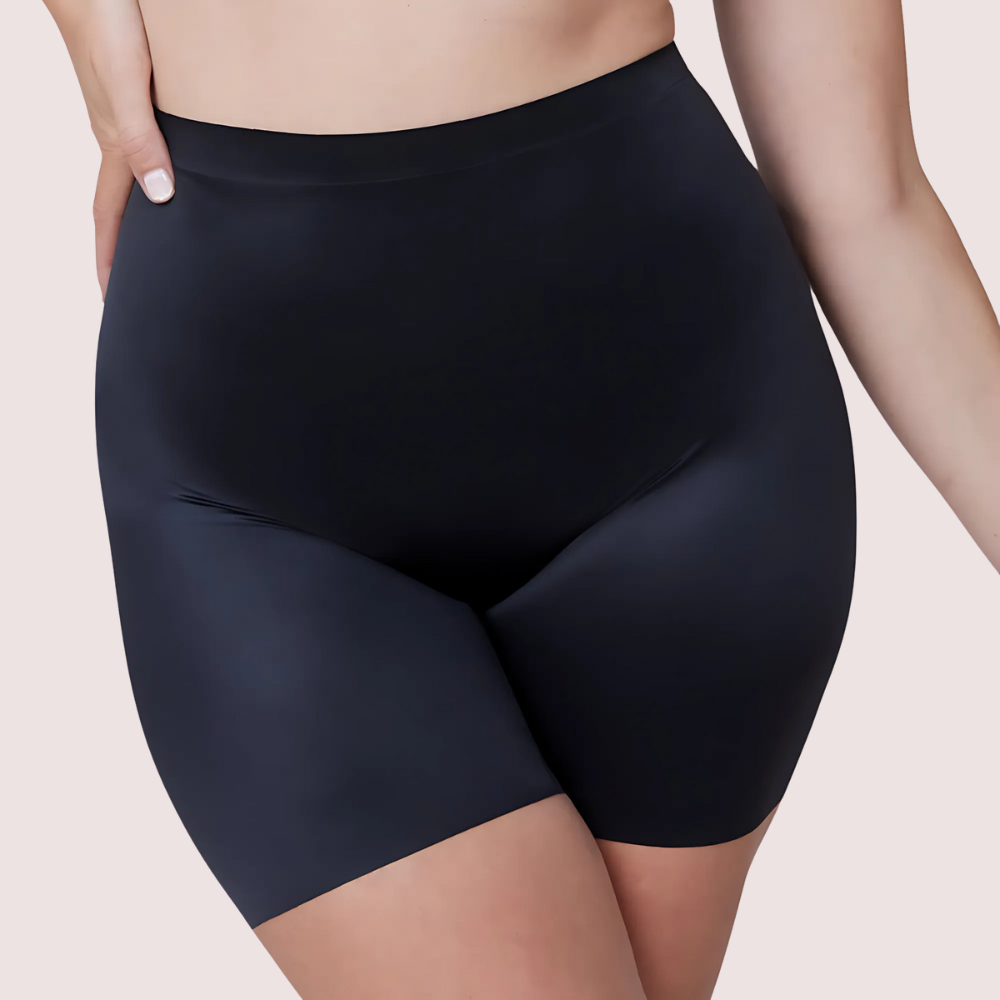 Black high-waisted shorts worn by a person on a beige background
