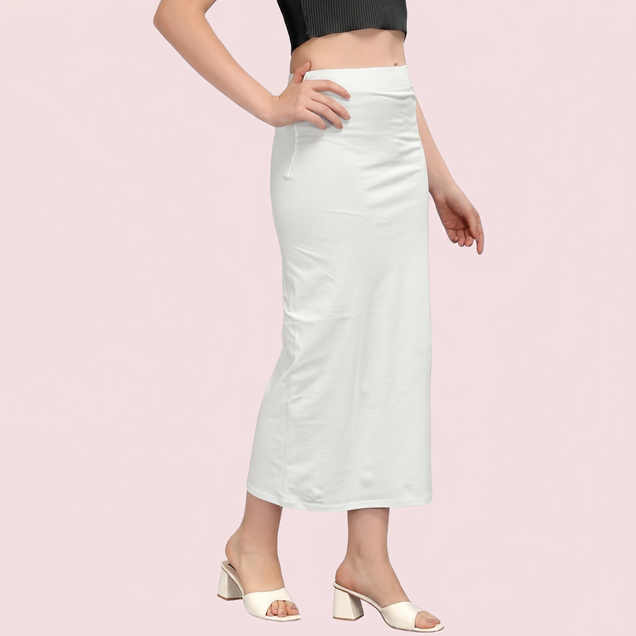 White satin skirt worn by a person on a pink background
