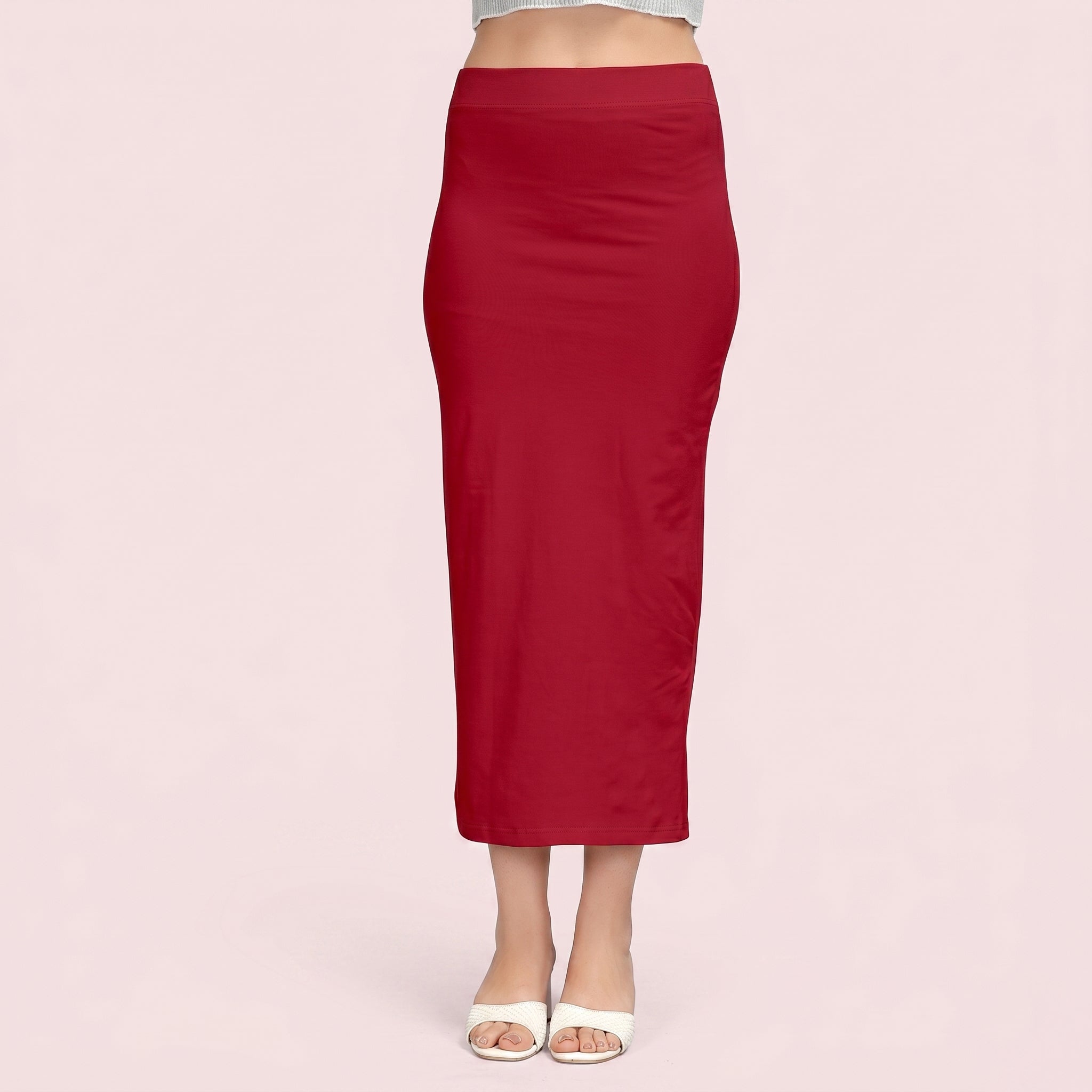 Red pencil skirt worn by a person on a light pink background