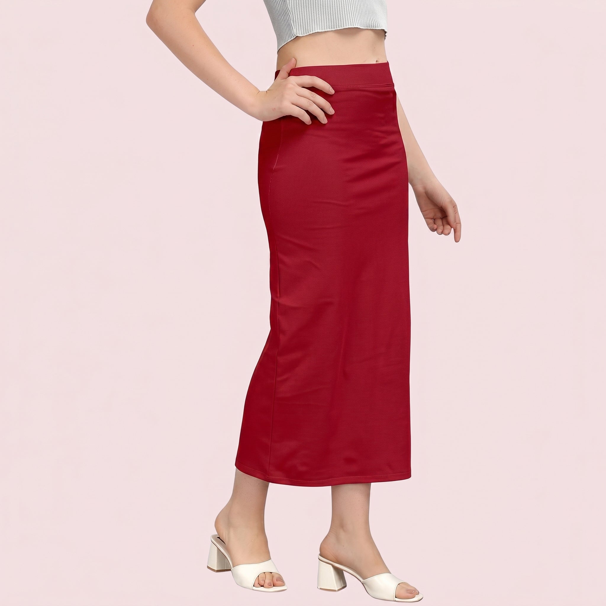 Red skirt worn by a person on a pink background