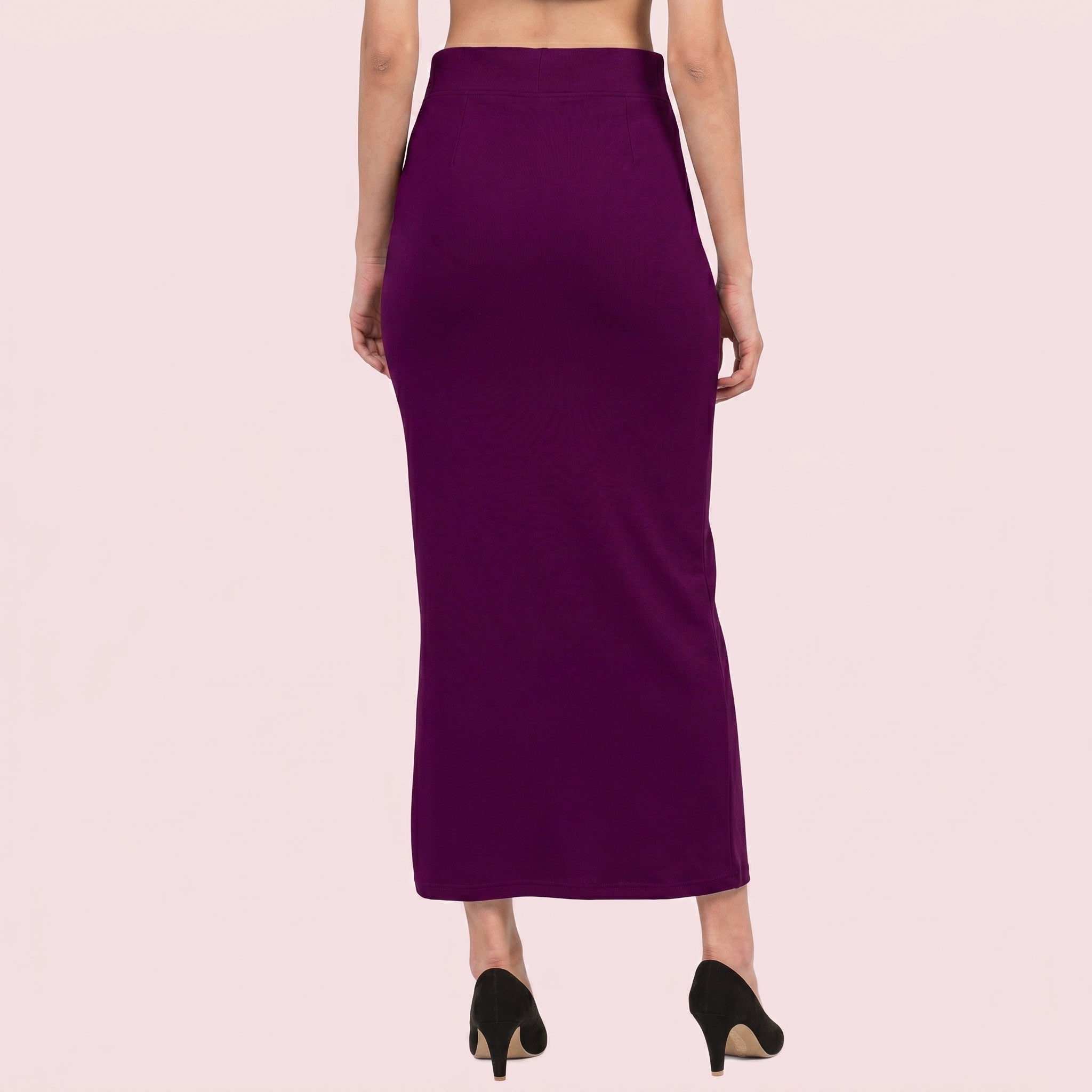 Purple pencil skirt worn by a person on a light pink background