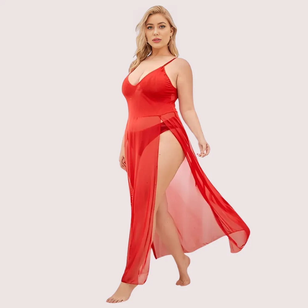 Woman wearing a red satin nightgown with a slit on a light pink background