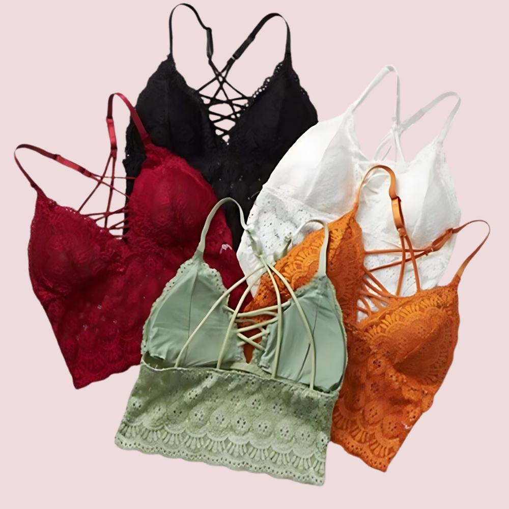 Set of five lace-trimmed bras in various colors on a pink background