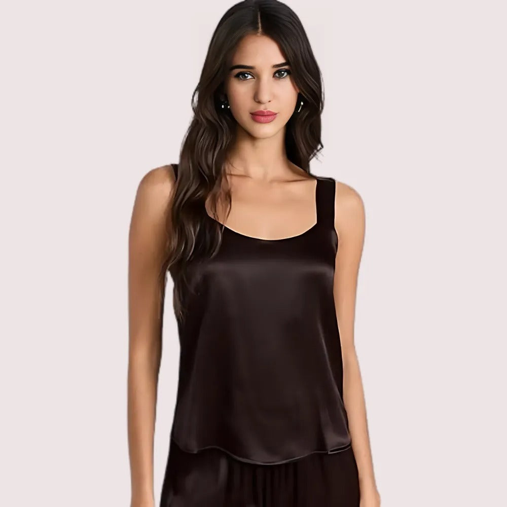 Woman wearing a brown satin tank top against a light pink background