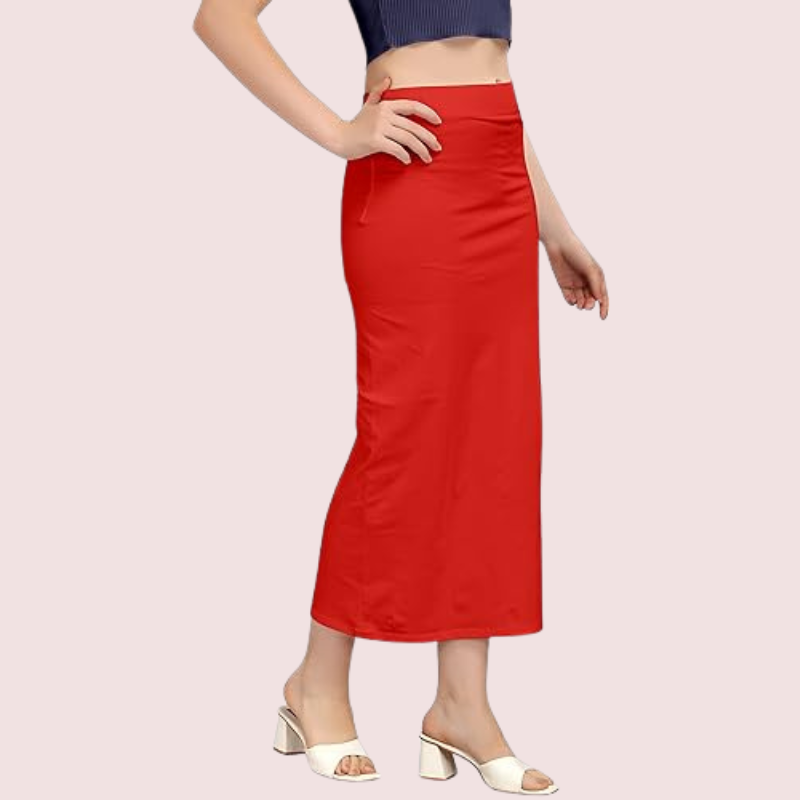 Red skirt worn by a person on a light pink background