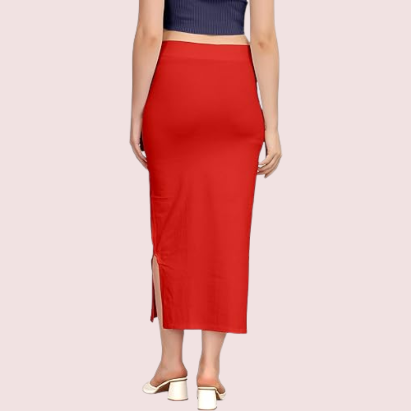 Red pencil skirt worn by a person on a light pink background