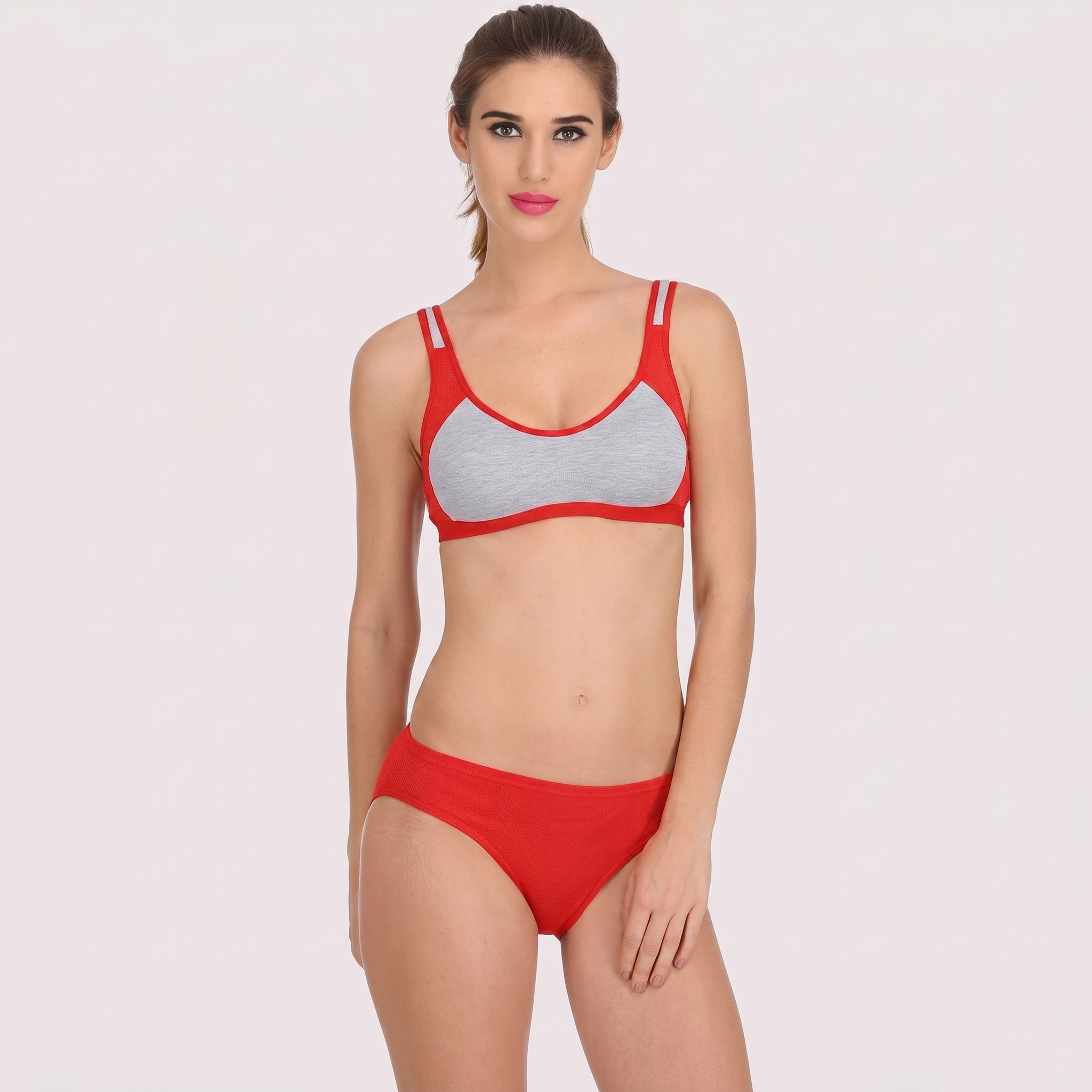 Woman wearing a red bikini with gray accents on a white background