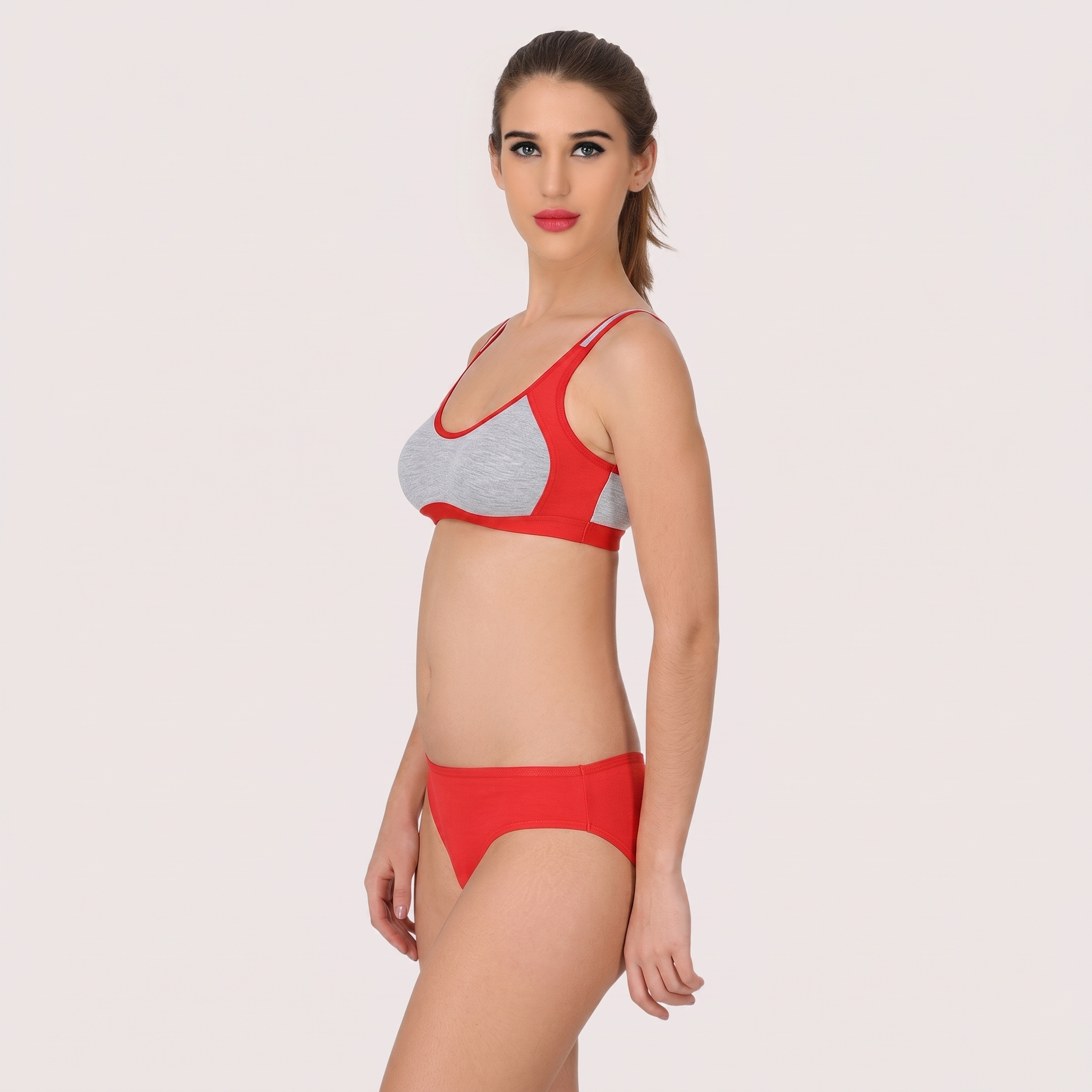 Woman wearing a red and gray bikini on a plain background