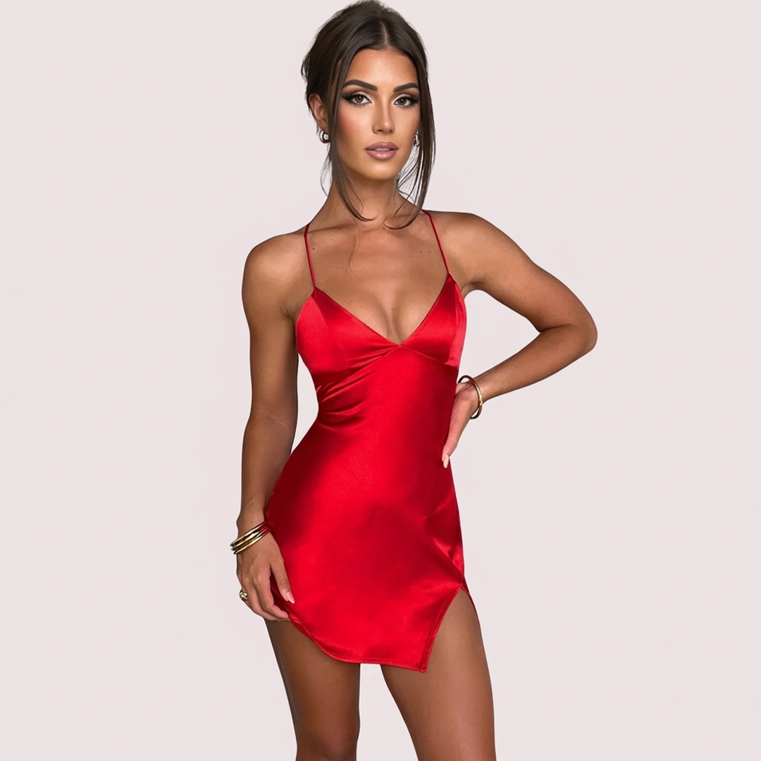 Woman wearing a red satin dress against a plain background