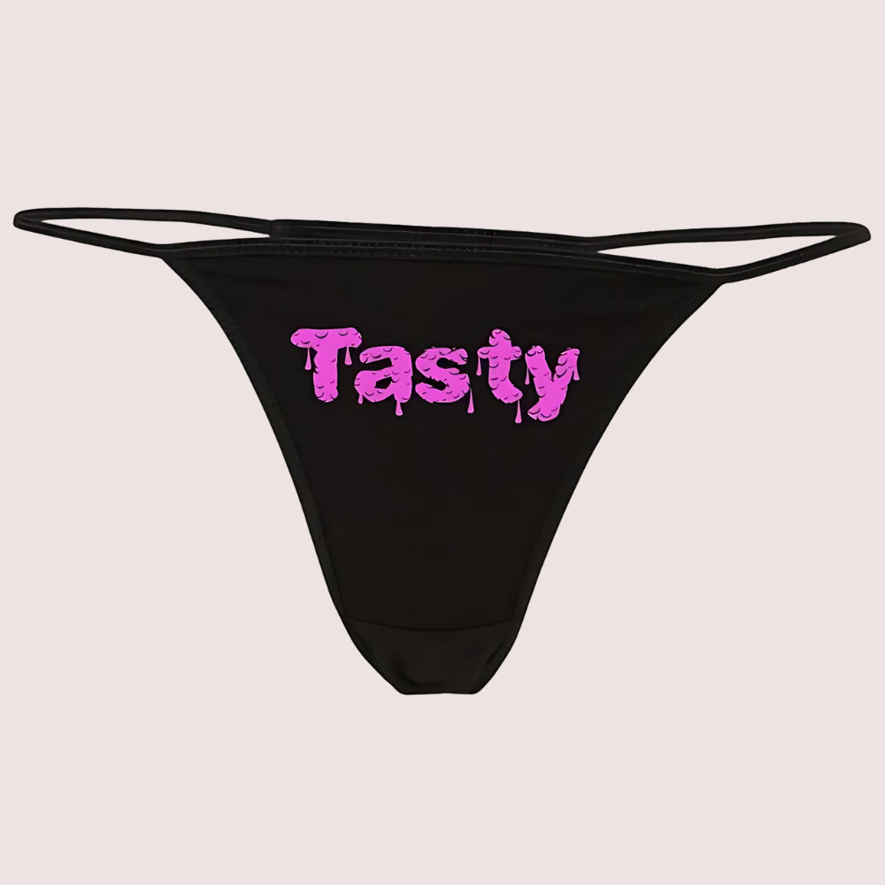 Black thong with pink 'Tasty' text on a light gray background