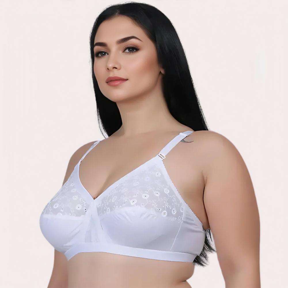 Woman wearing a white bra with floral embroidery 