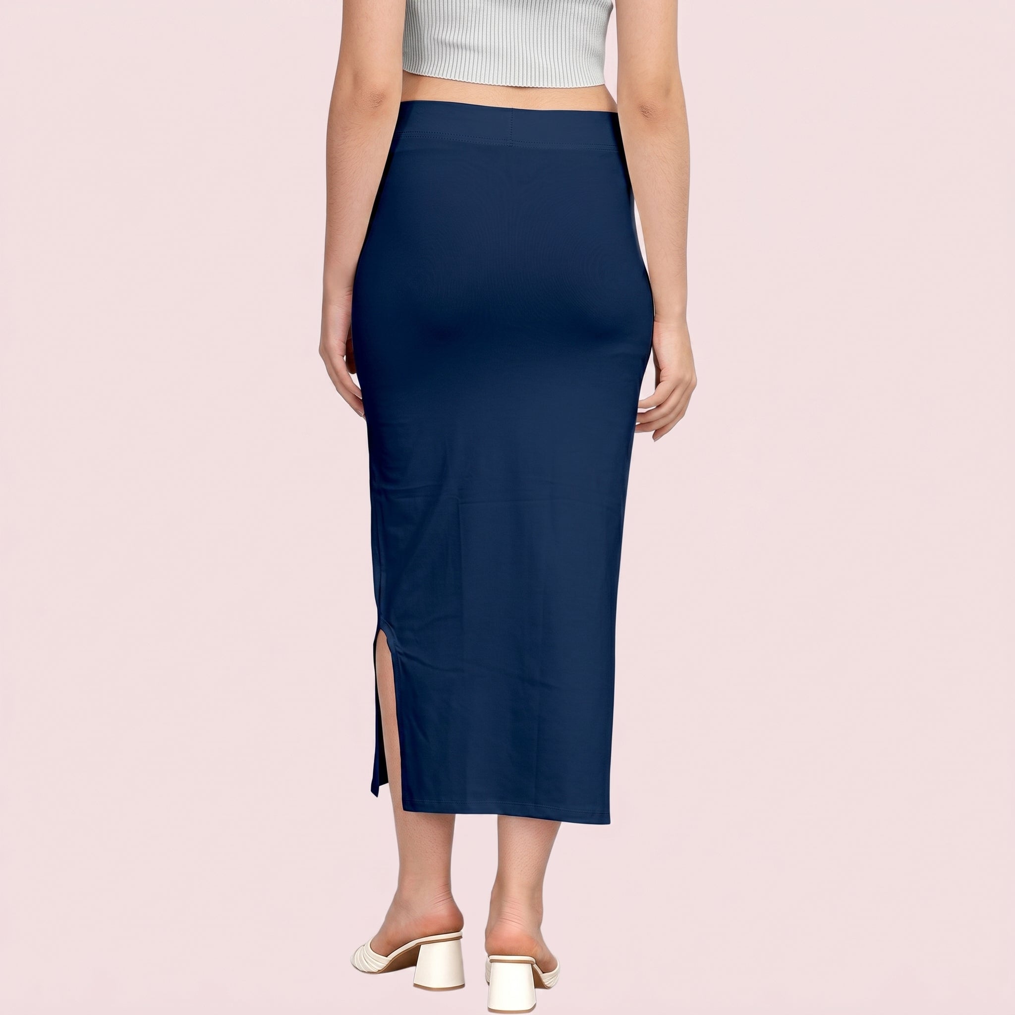 Navy blue pencil skirt worn by a person on a pink background