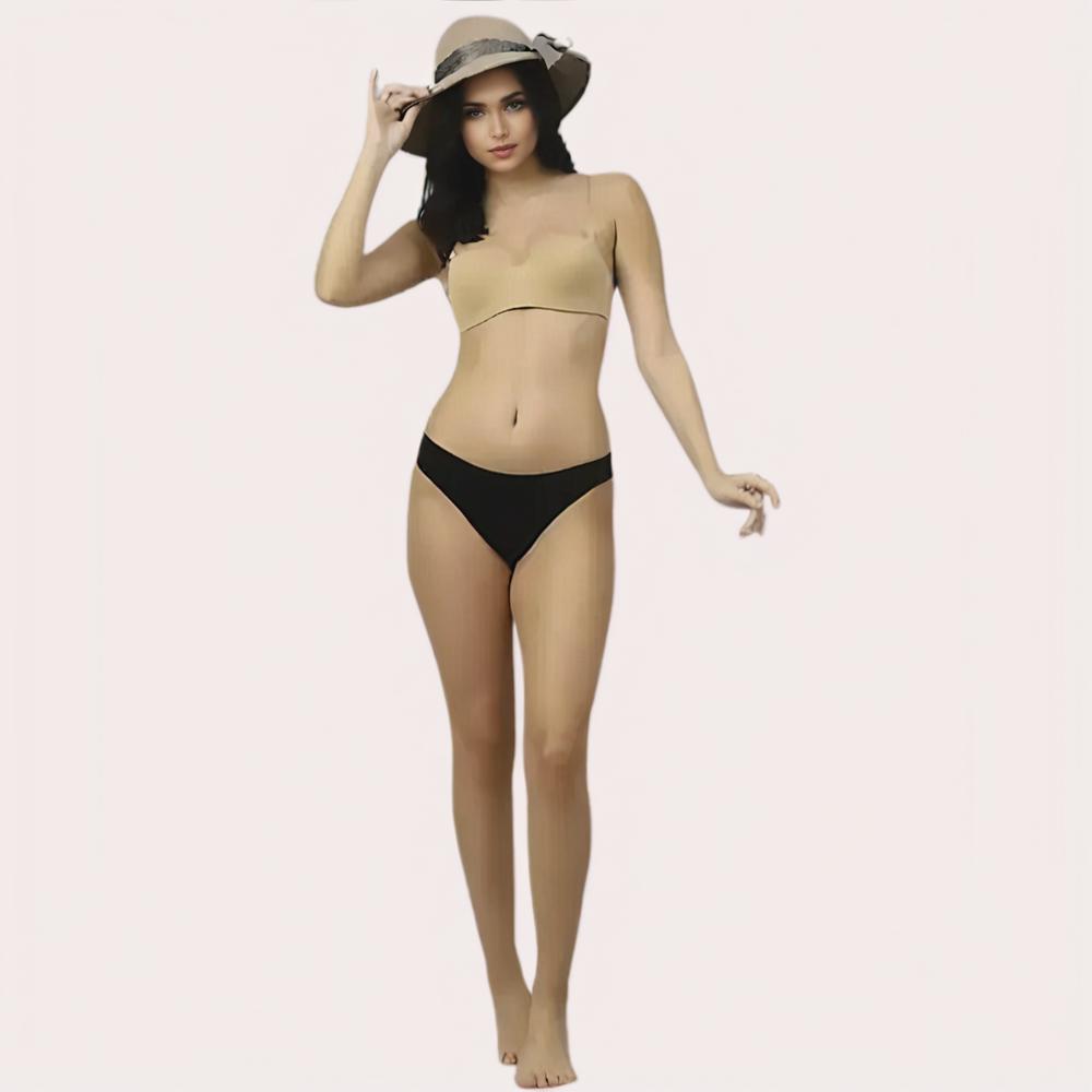 Woman wearing a beige bikini top and black bottoms 