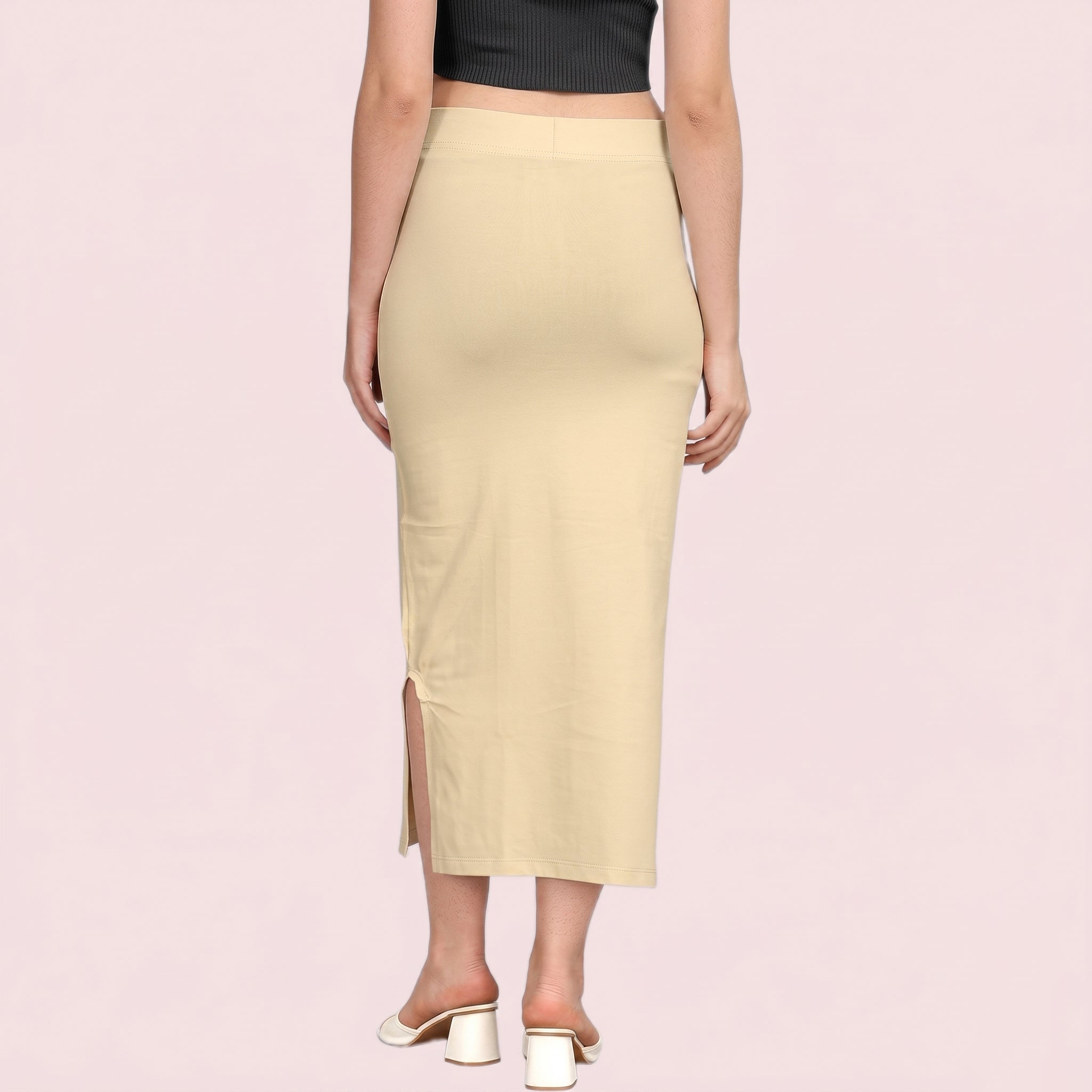 Beige pencil skirt worn by a person on a pink background