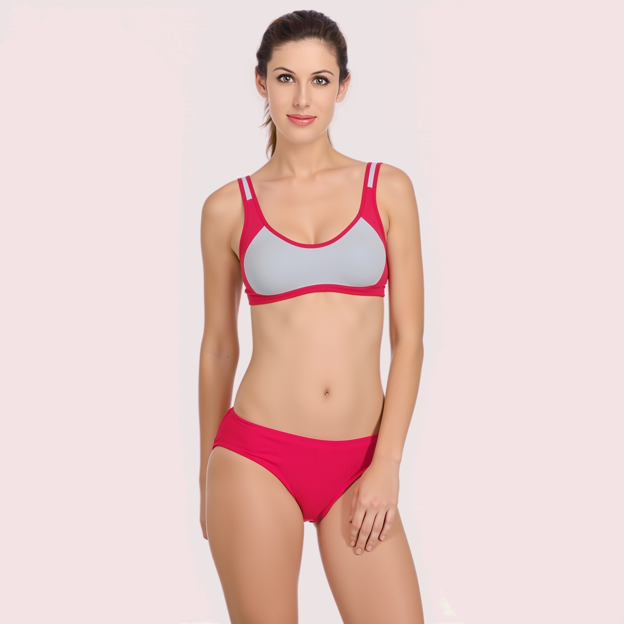 Woman wearing a pink and gray bikini on a light pink background