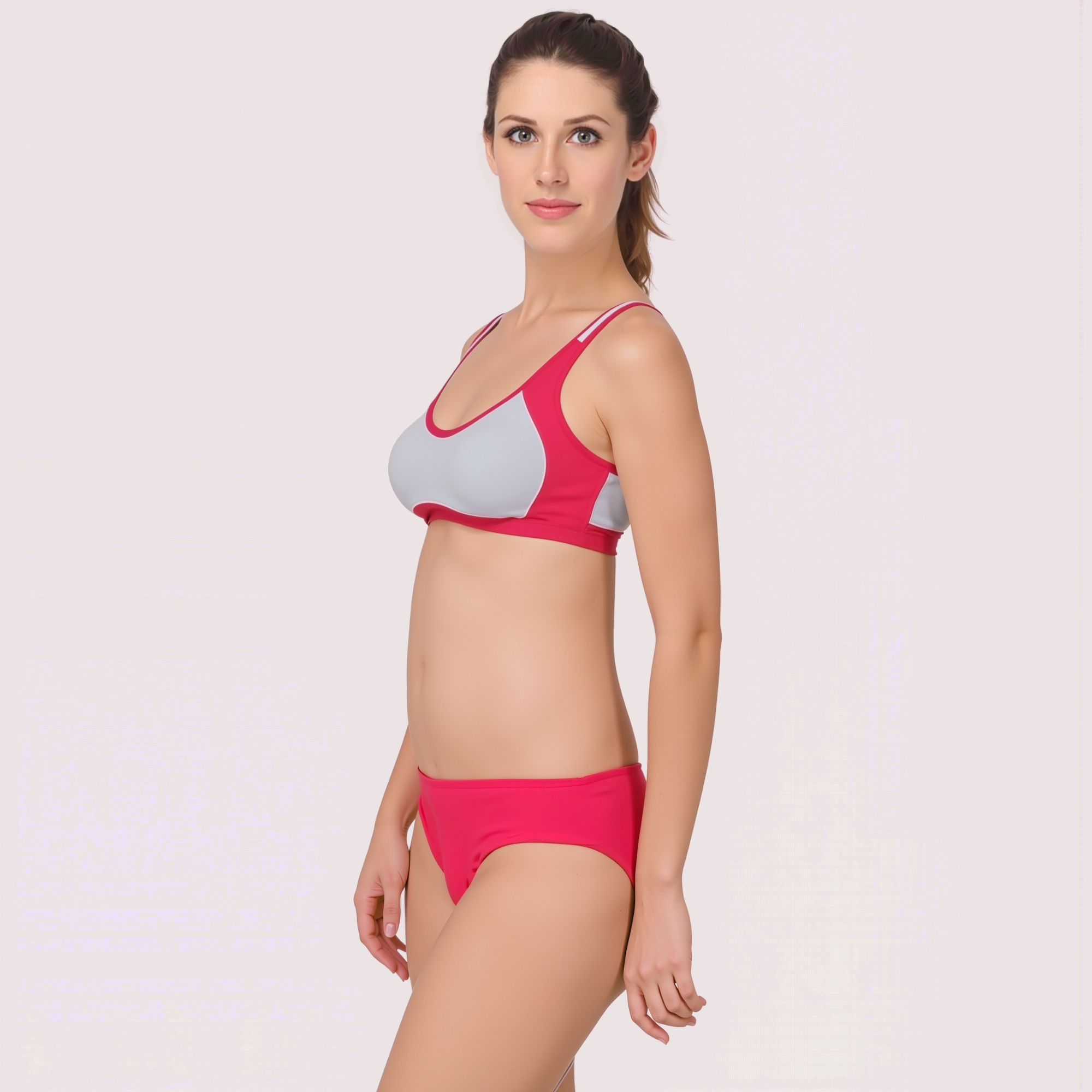 Woman wearing a pink and gray bikini on a white background