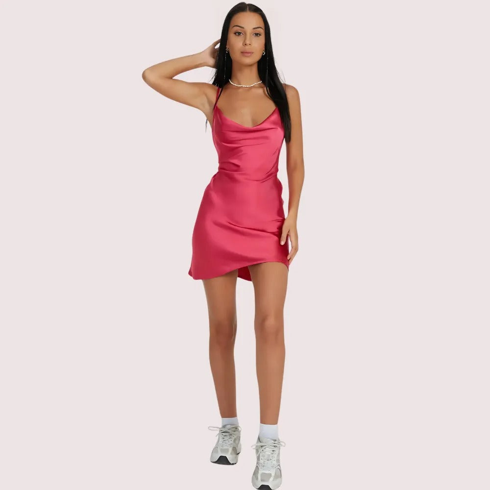 Woman wearing a pink dress on a light pink background