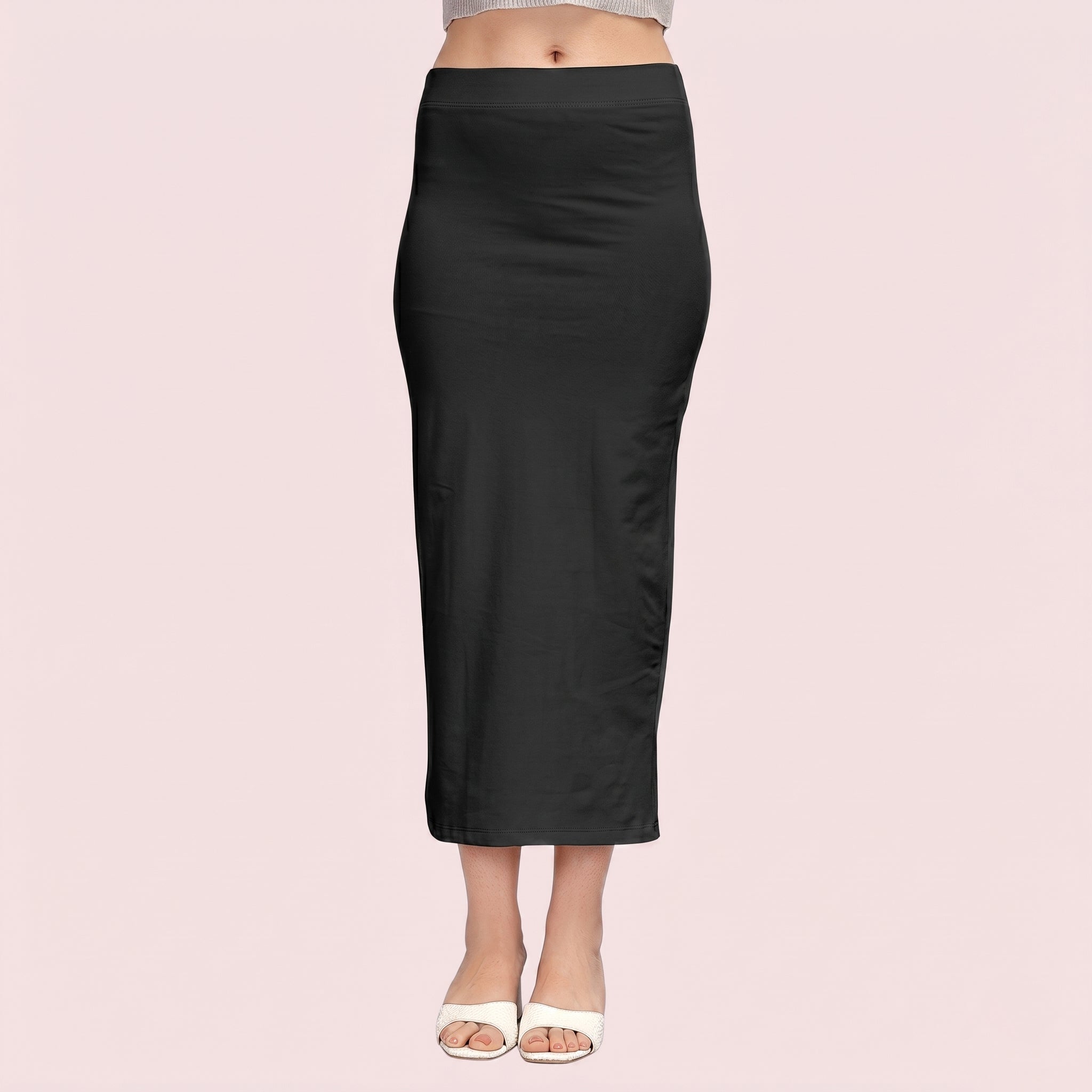 Black pencil skirt worn by a person on a light pink background