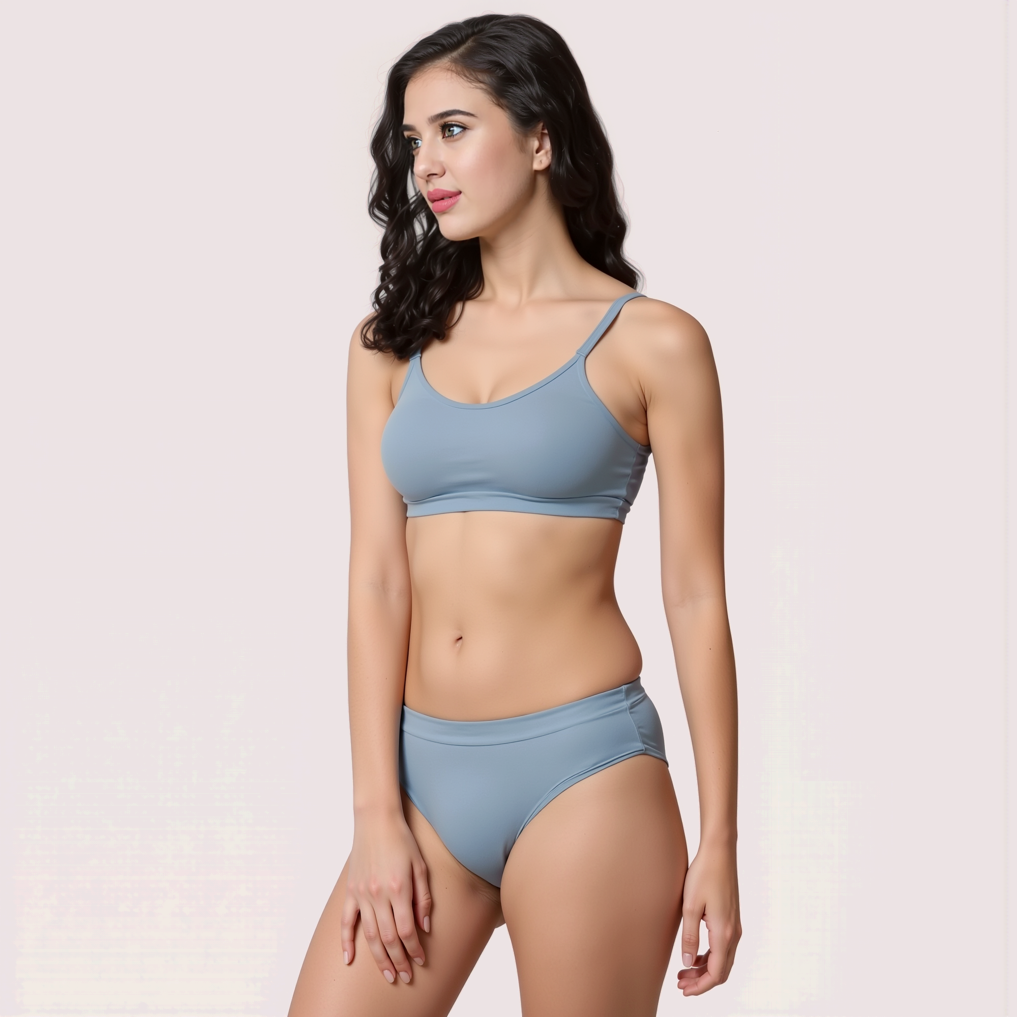 Woman wearing a light blue bikini on a plain background