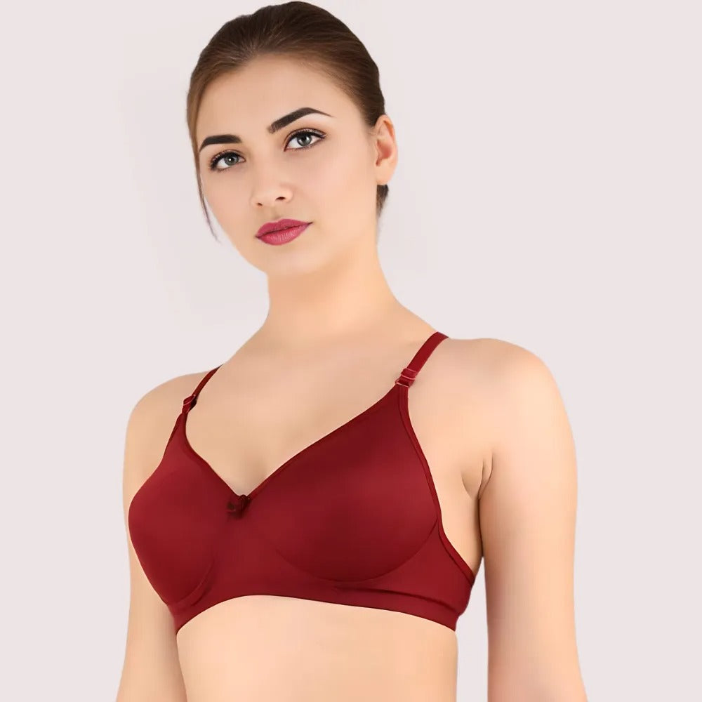 Woman wearing a red bra against a plain background