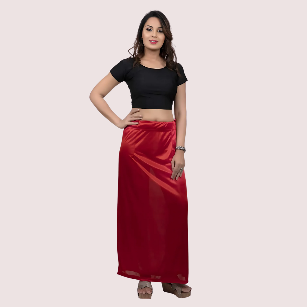 Woman wearing a black top and red skirt on a beige background