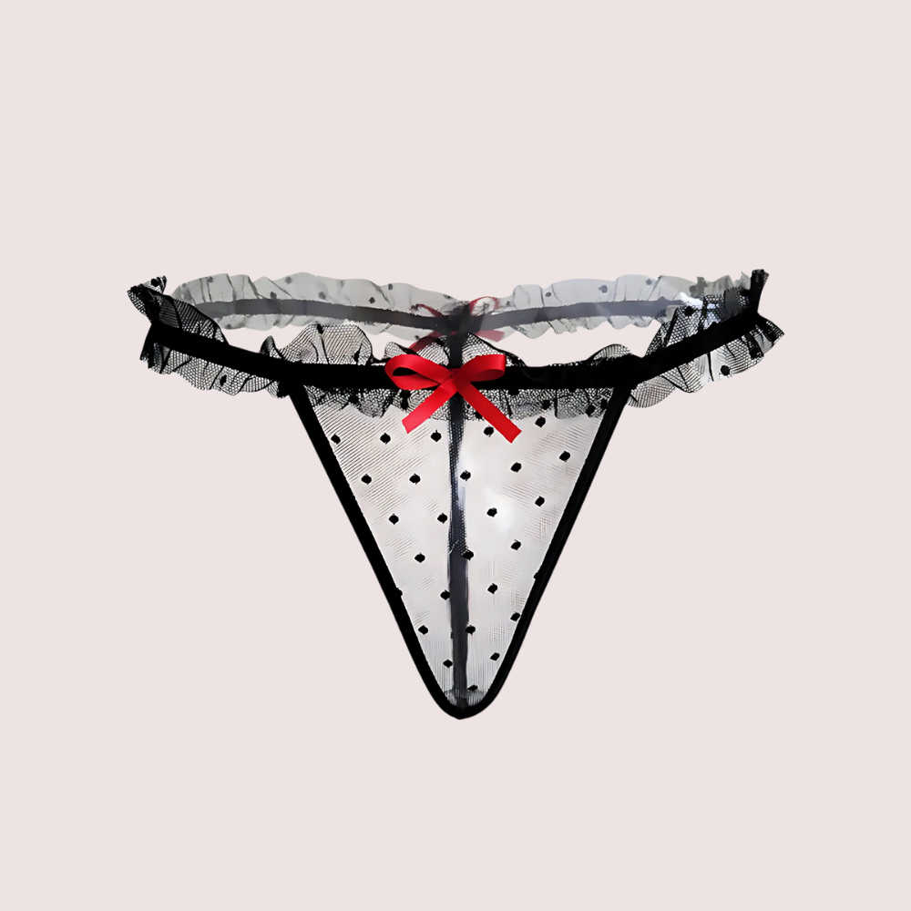 Translucent lace thong with a red bow on a light gray background