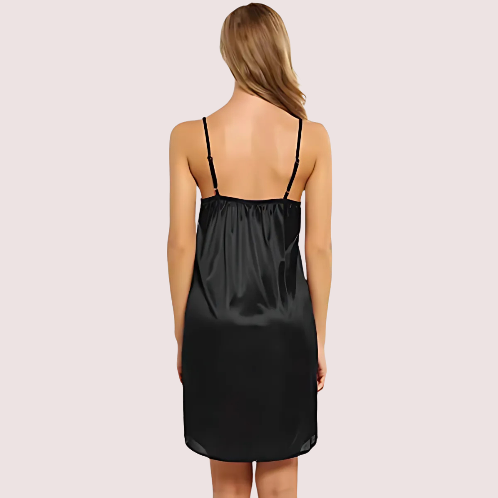 Black satin nightgown worn by a model on a light pink background