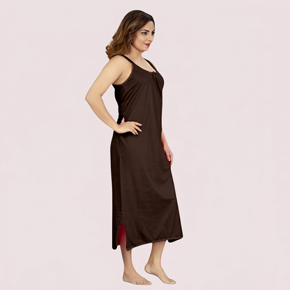 Woman wearing a brown sleeveless dress on a light pink background