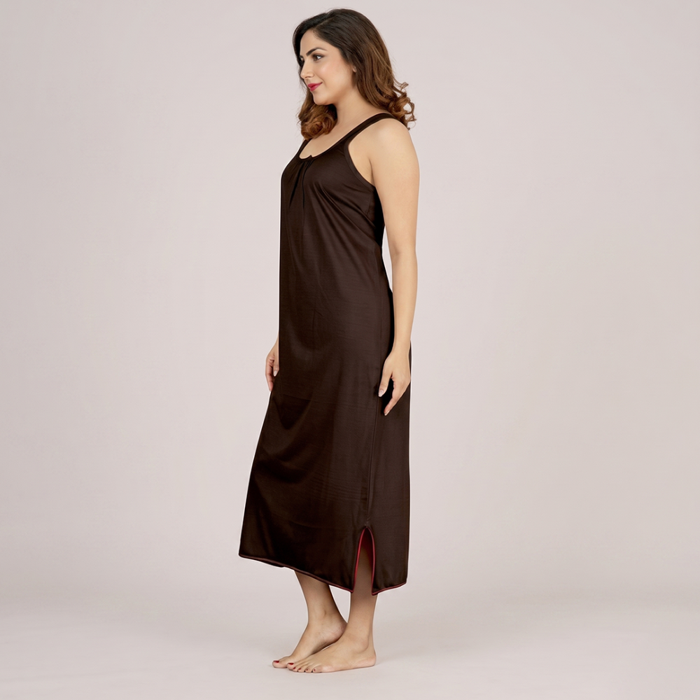 Woman wearing a brown dress on a plain background